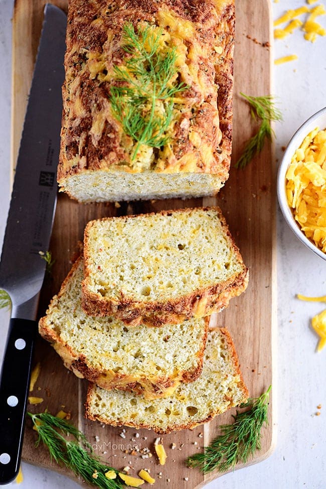 sliced loaf of cheese bread on a wood board