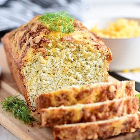 sliced loaf of cheese bread on wood board