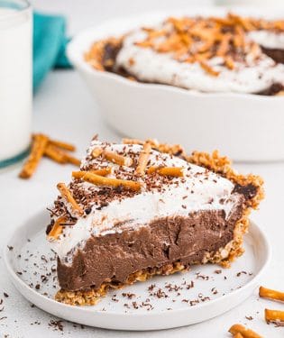 chocolate cream pie with a pretzel crust on a white plate