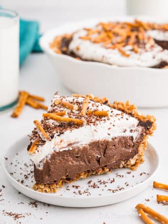 chocolate cream pie with a pretzel crust on a white plate