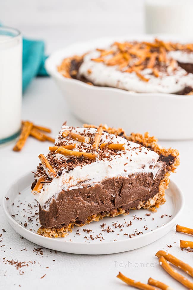 chocolate cream pie with a pretzel crust on a white plate