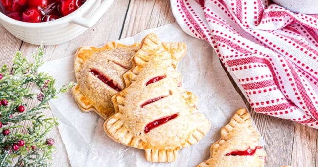Holiday Tree Cherry Hand Pies on a counter with a red and white towel