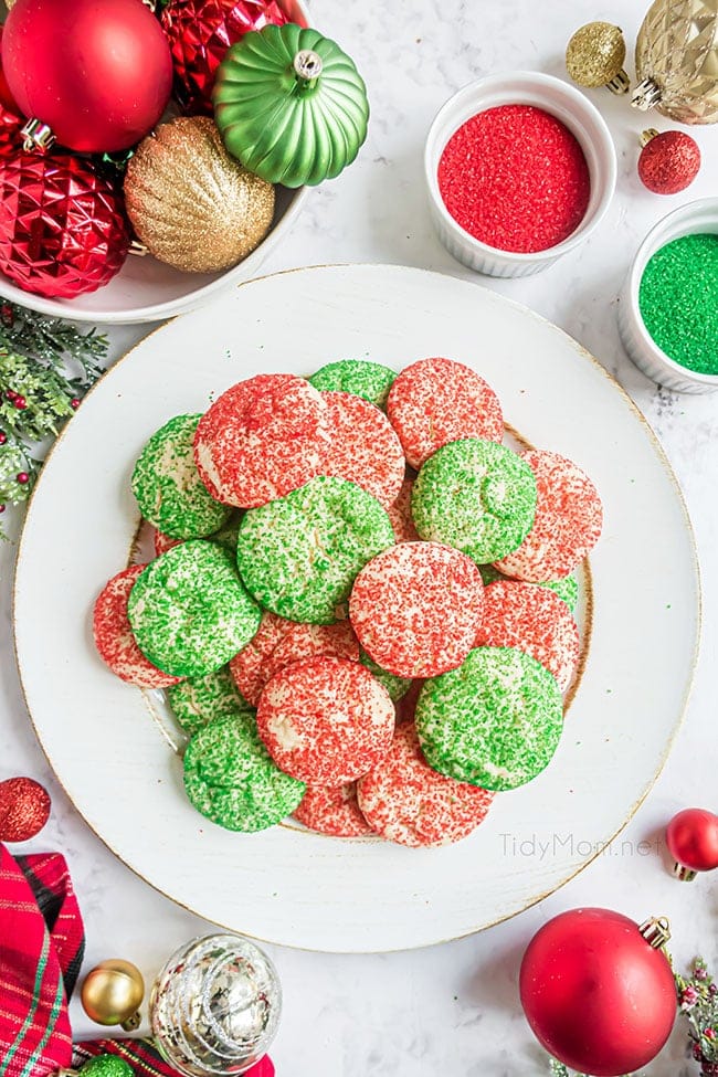 A pile of red and green Christmas drop cookies on a white platter