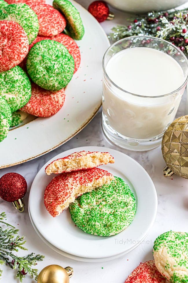 red and green Christmas drop cookies on a plate, with one broke in half