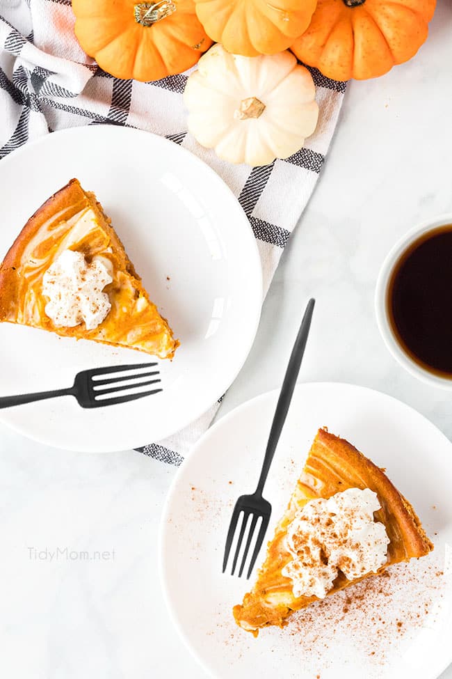 2 slices of pumpkin cheesecake pie on white plates