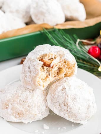 close up of snowball cookies in a green dish