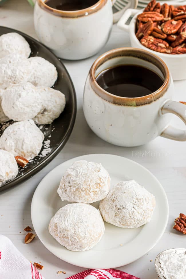 russian tea cakes on a plate with a hot mug of coffee