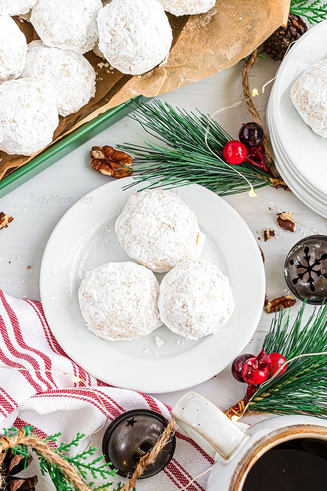 snowball cookies on a plate with holiday decor