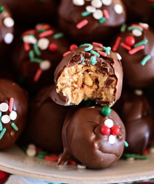 chocolate peanut butter balls with Christmas sprinkles