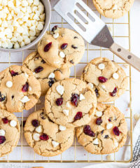 cranberry cookies on a gold cooling rack with spatula