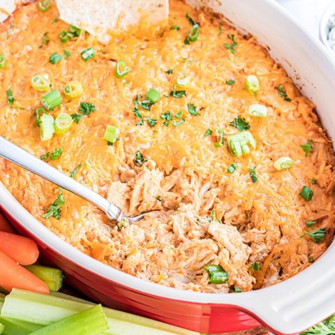 freshly baked buffalo chicken dip in a red serving dish