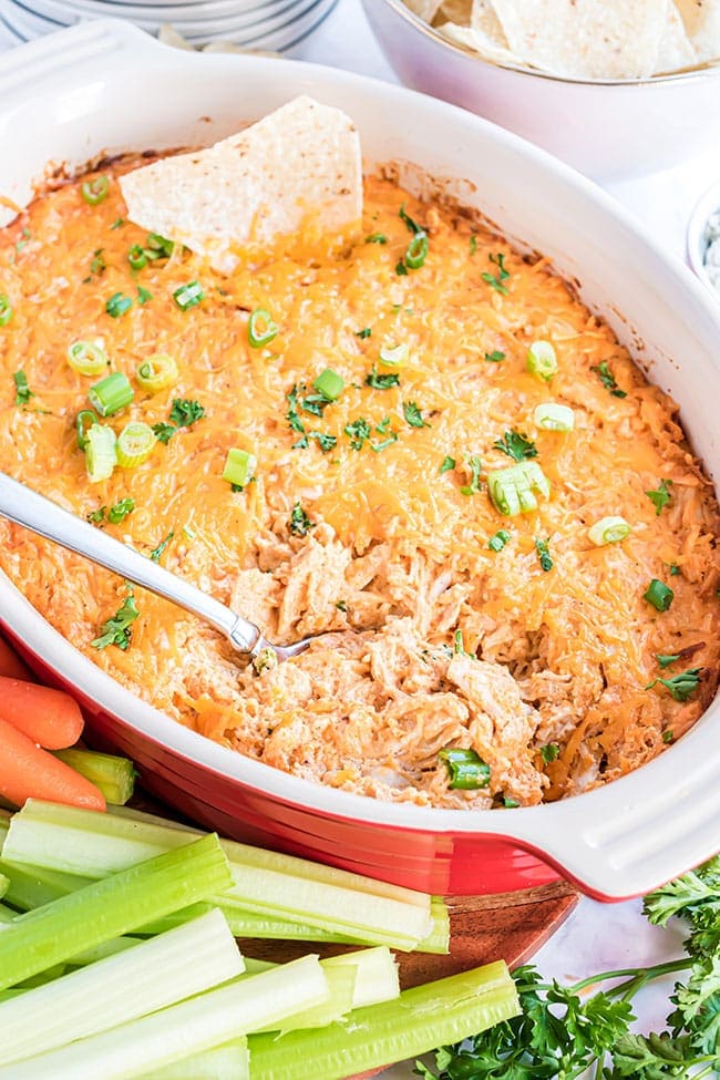 freshly baked buffalo chicken dip in a red serving dish