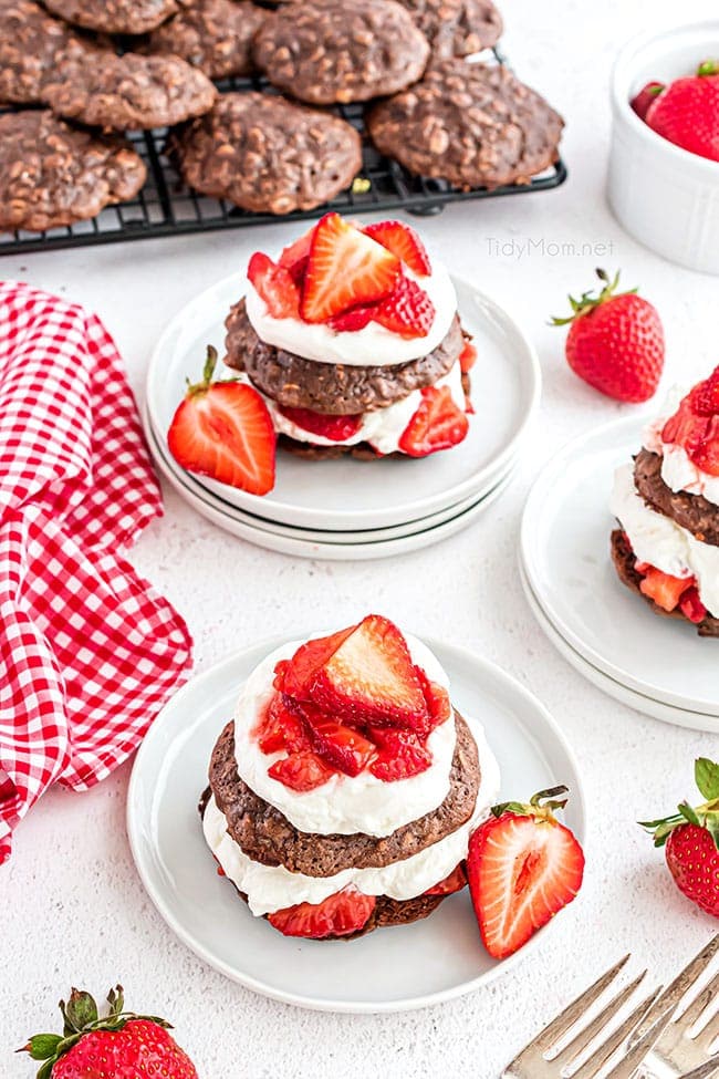 Brownie strawberry shortcake with homemade whipped cream on white plates