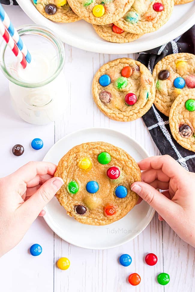 hands holding a homemade m&m cookie