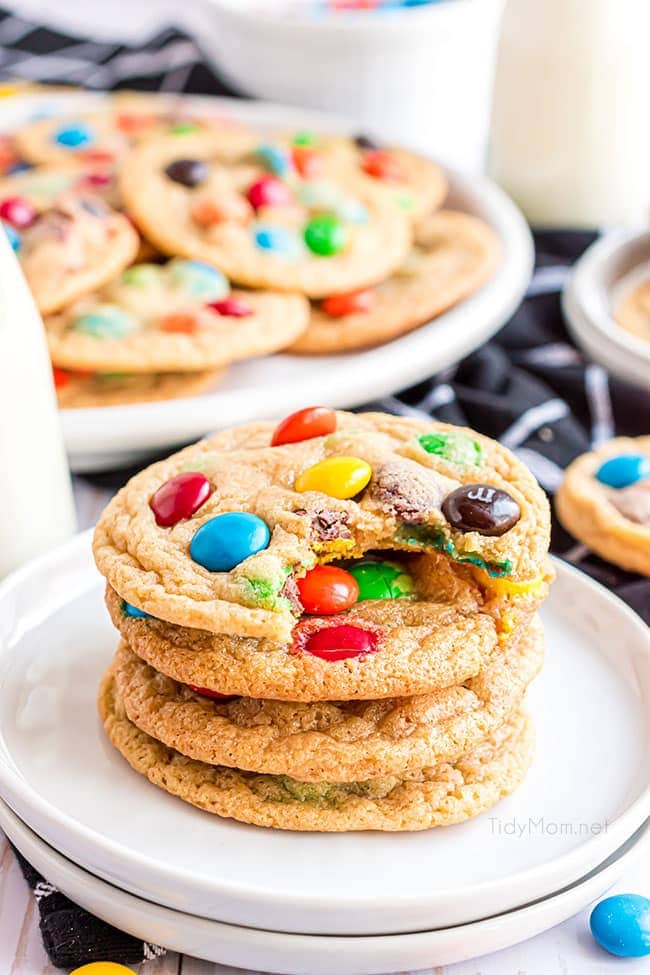 a stack of the best m&m cookies on a white plate