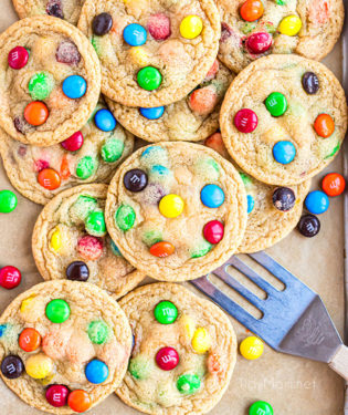 a pile of easy M&M cookies on a cookie sheet