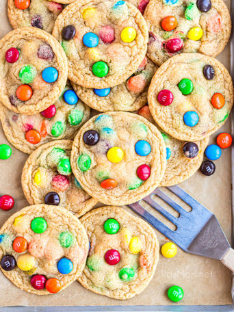 a pile of easy M&M cookies on a cookie sheet
