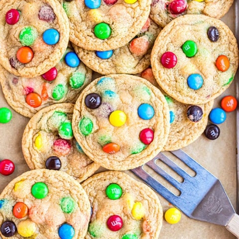 a pile of easy M&M cookies on a cookie sheet