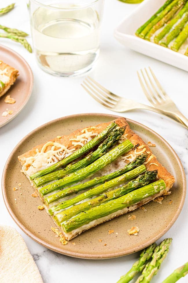 Asparagus tart with gruyere cheese on a brown plate