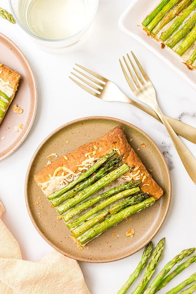 a slice of asparagus tart on a brown plate