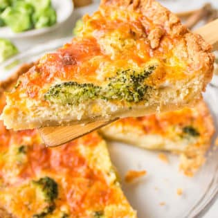 dishing up a serving of broccoli cheddar quiche
