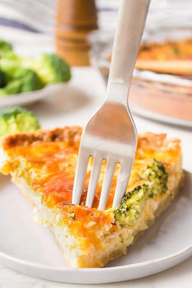 fork in a serving of Easy Broccoli Cheddar Quiche