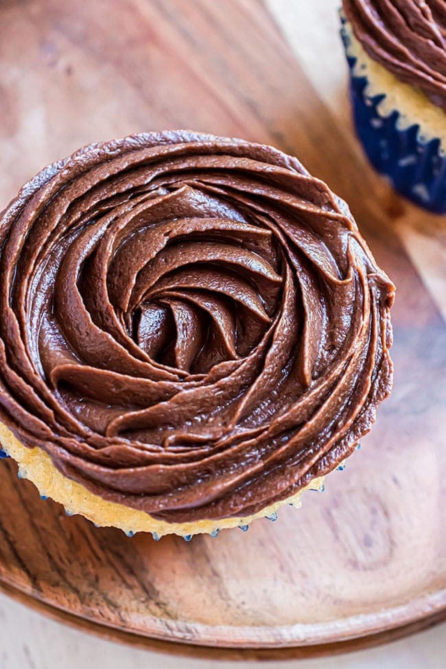 simple chocolate icing piped on a cupcakes