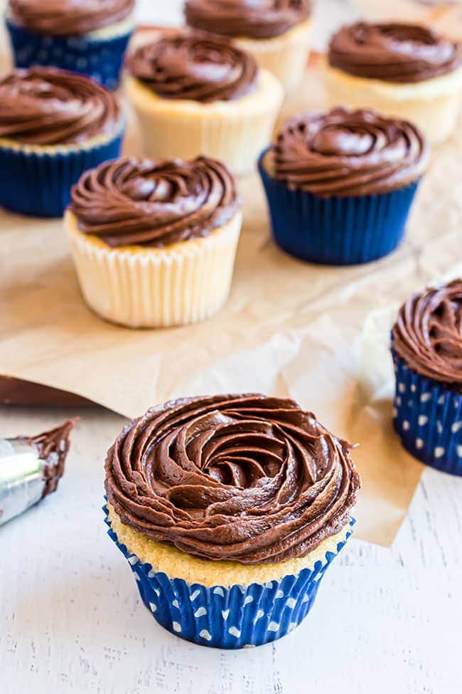 simple chocolate icing piped on to vanilla cupcakes