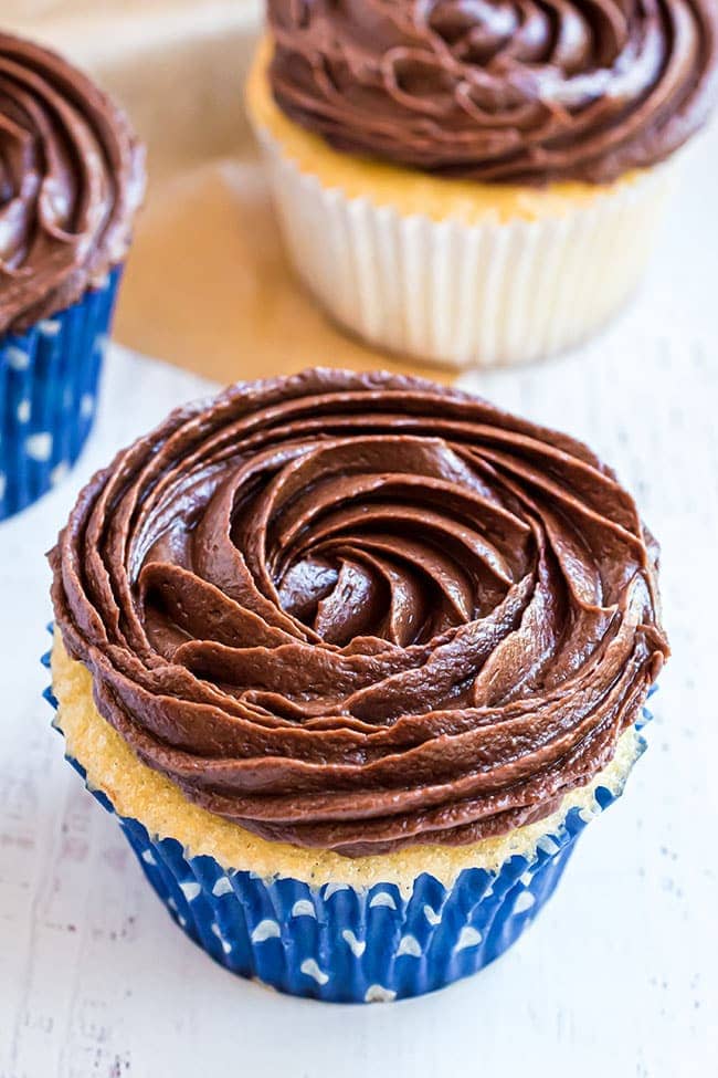 easy chocolate buttercream frosting on a cupcake in a blue wrapper