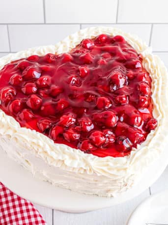 heart shaped cheery cake with butter cream frosting