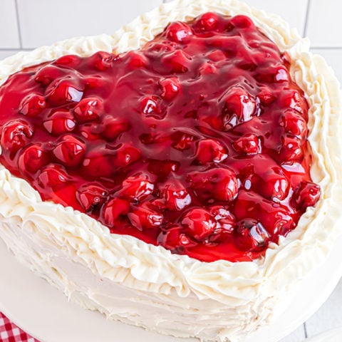 heart shaped cheery cake with butter cream frosting