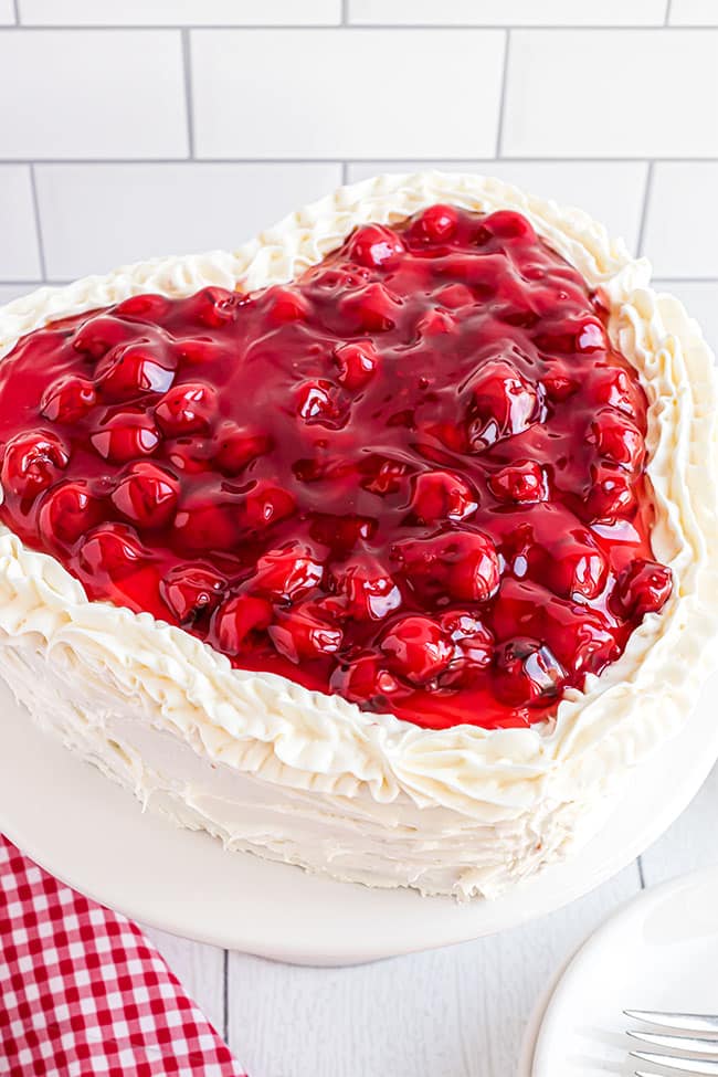 heart shaped cheery cake with butter cream frosting