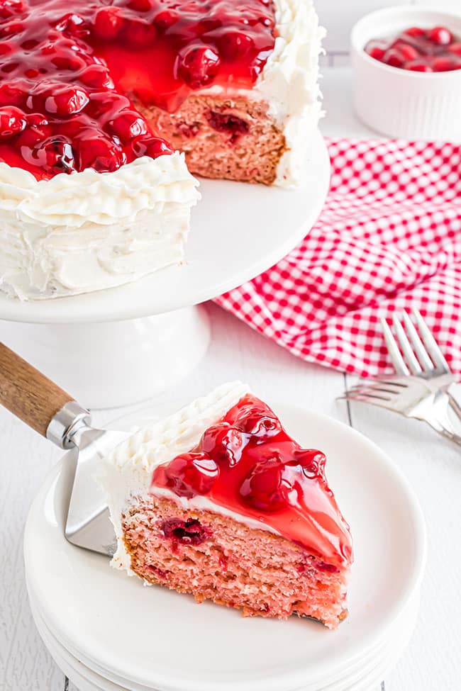 slice of heart shaped cheery cake on white plate