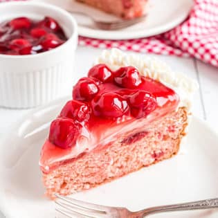 heart shaped cheery cake with cherry pie filling on top