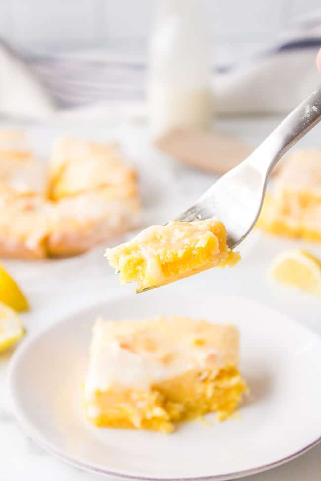 fork with a bite of a lemon brownie