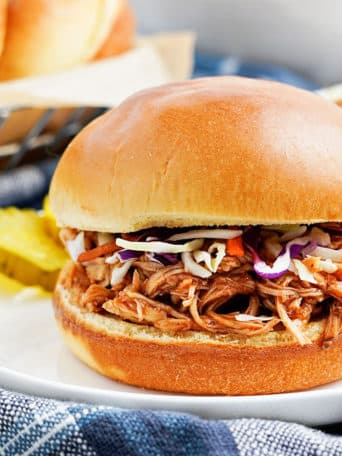 Slow Cooker Pulled Chicken on a bun with coleslaw