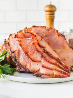 honey glazed ham on a white platter