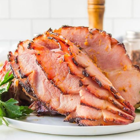 honey glazed ham on a white platter