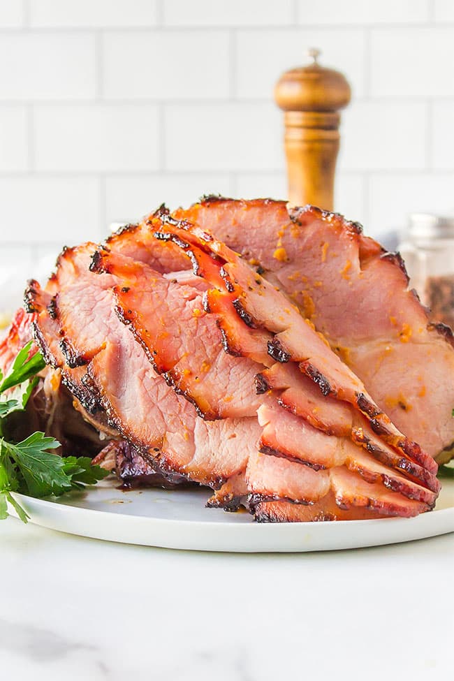 honey glazed ham on a white platter