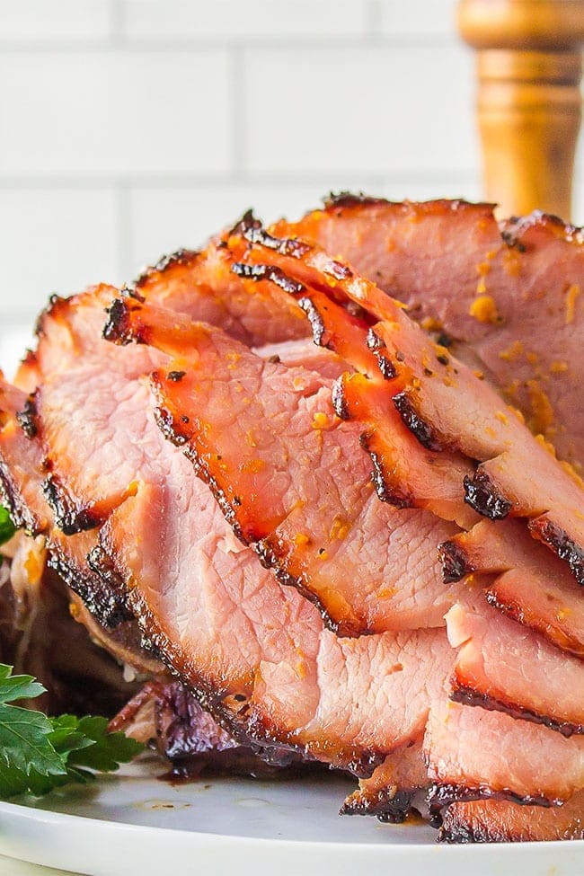 Honey Glazed Ham With Apricot sliced and on a platter