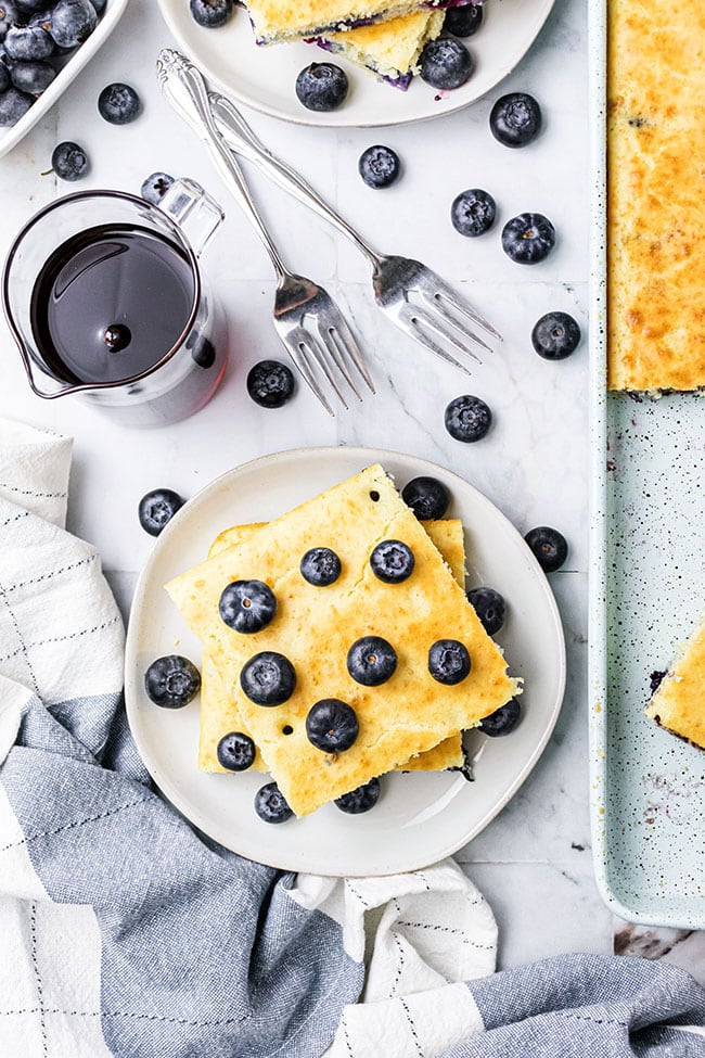 Easy oven baked pancakes with blueberries on a white plate