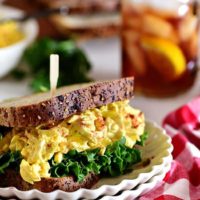 classic egg salad sandwich on a stack of plates