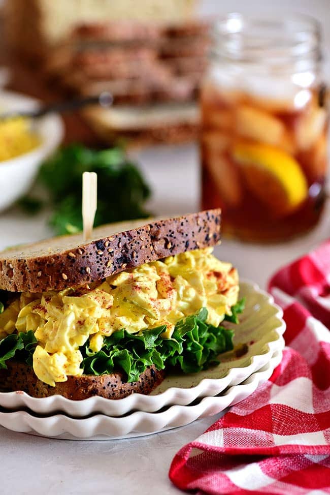 classic egg salad sandwich on a stack of plates