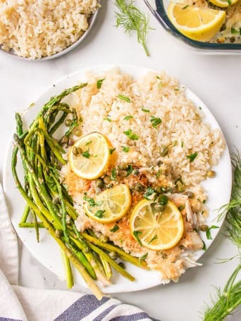 Lemon Parmesan Tilapia on a plate with asparagus and rice