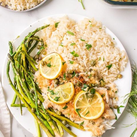 Lemon Parmesan Tilapia on a plate with asparagus and rice