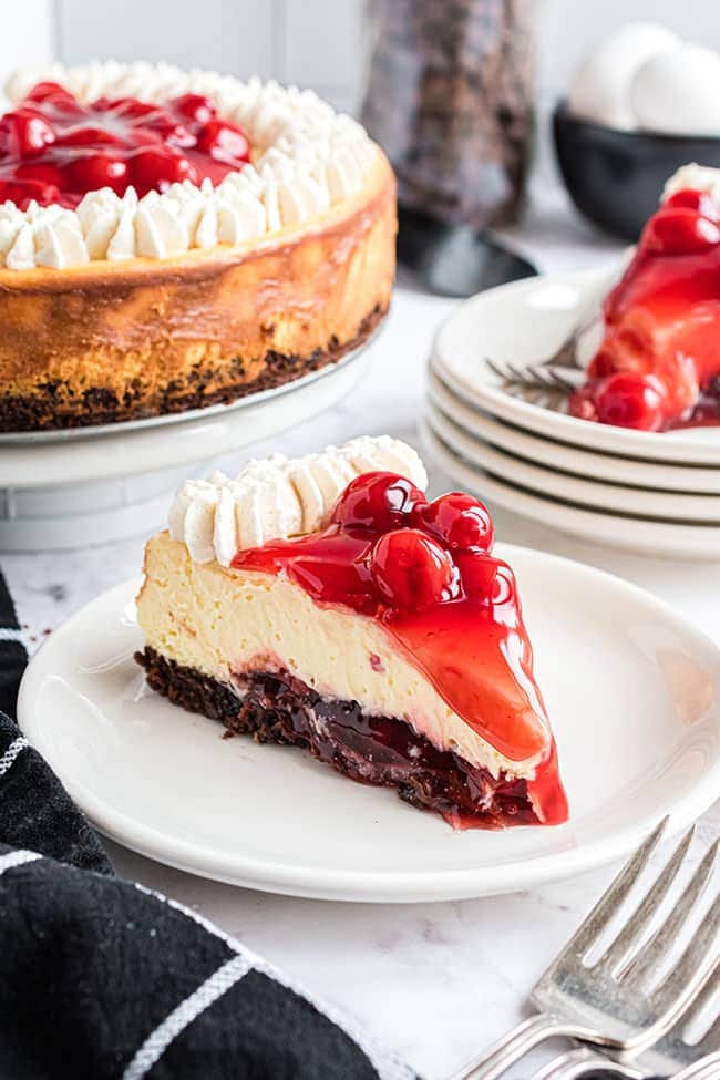 slice of Brownie bottom cherry cheesecake on a white plate