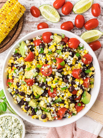 roasted corn black bean avocado salad in a white bowl