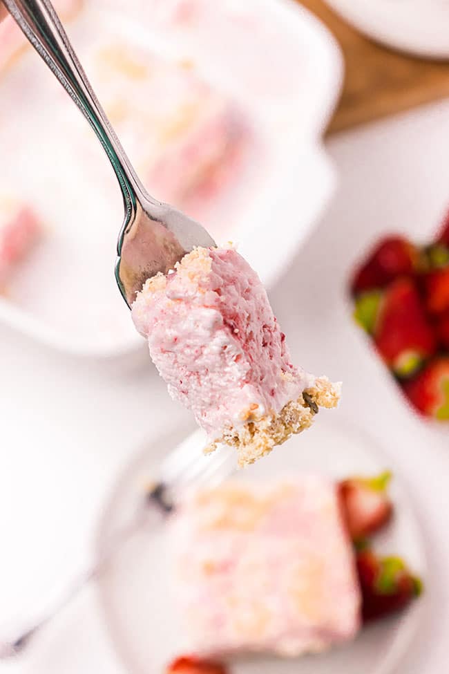 A bite of Frozen Strawberry Dessert on a fork