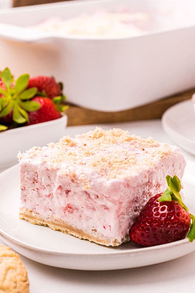 Serving of easy frozen strawberry dessert with cool whip on a plate