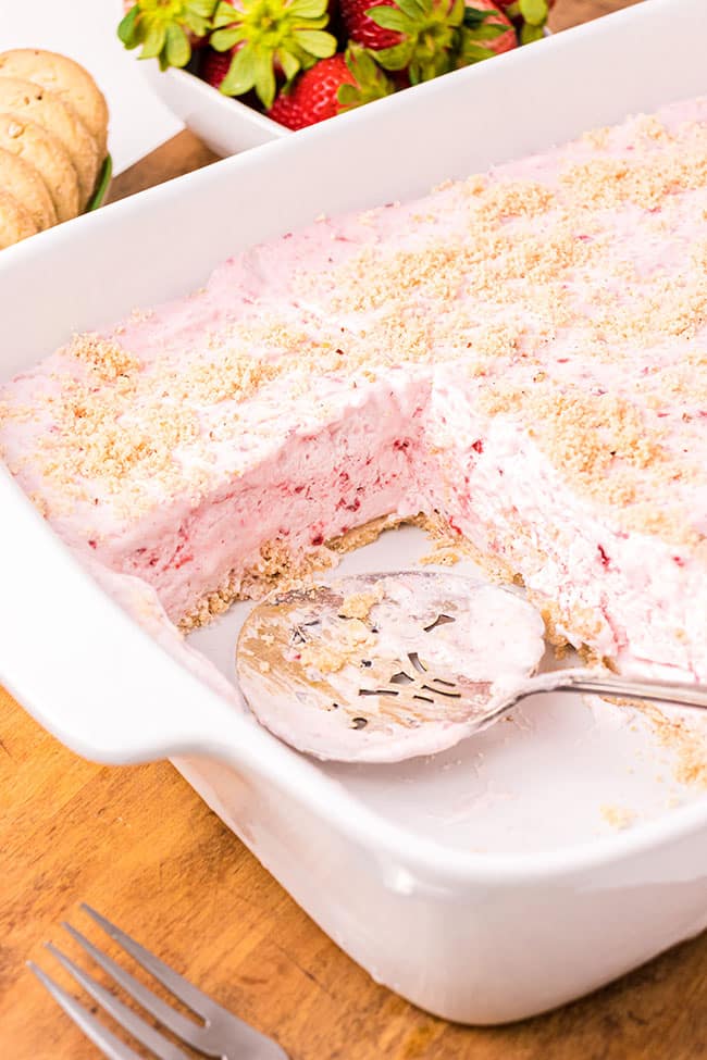 Pan of frozen strawberry dessert with pecan crust